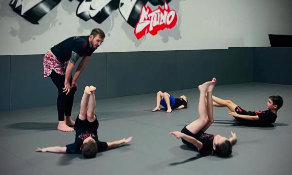 Kids participating in a jiu jitsu class