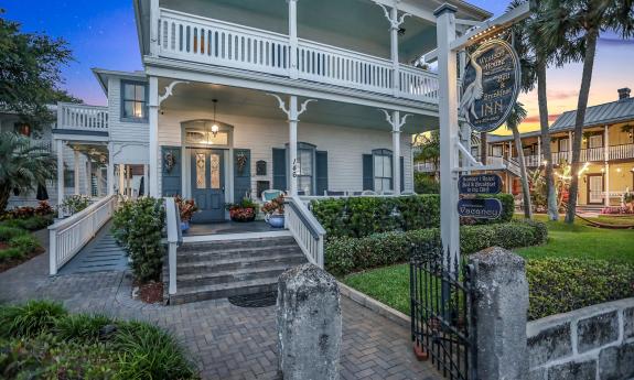 The front entrance of the Bayfront Wescott House, with wide steps and teal shutters