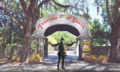 A conquistador standing in front of the Fountain of Youth gate