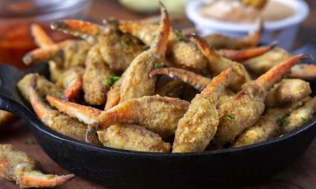 Blue crab legs, fried served with a spicy sauce at Harry's