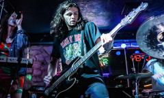 A musician playing a guitar on stage