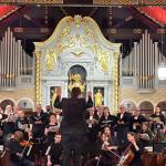 The composer faces the St. Augustine Community Chorus as they perform in the Cathedral Basilica of St. Augustine