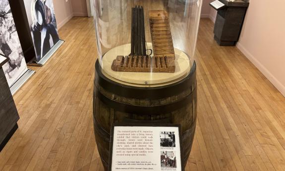 A display showing a cigar mold, and photos of the actors who educated the public during the 400th anniversary of St. Augustine
