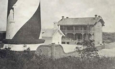 The base of the lighthouse stands next to the ramshackle Keepers' House 